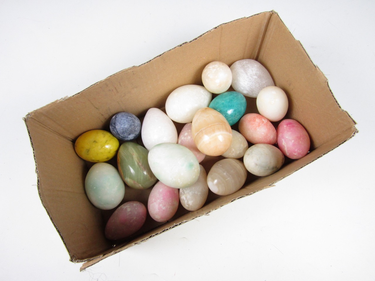 A quantity of various stoneware eggs