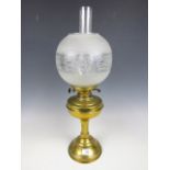 A brass oil lamp with glass globe