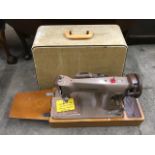 A cased electric Singer sewing machine 201