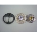 Three items of Scottish Jewellery, comprising a silver plaid type brooch with amethyst coloured