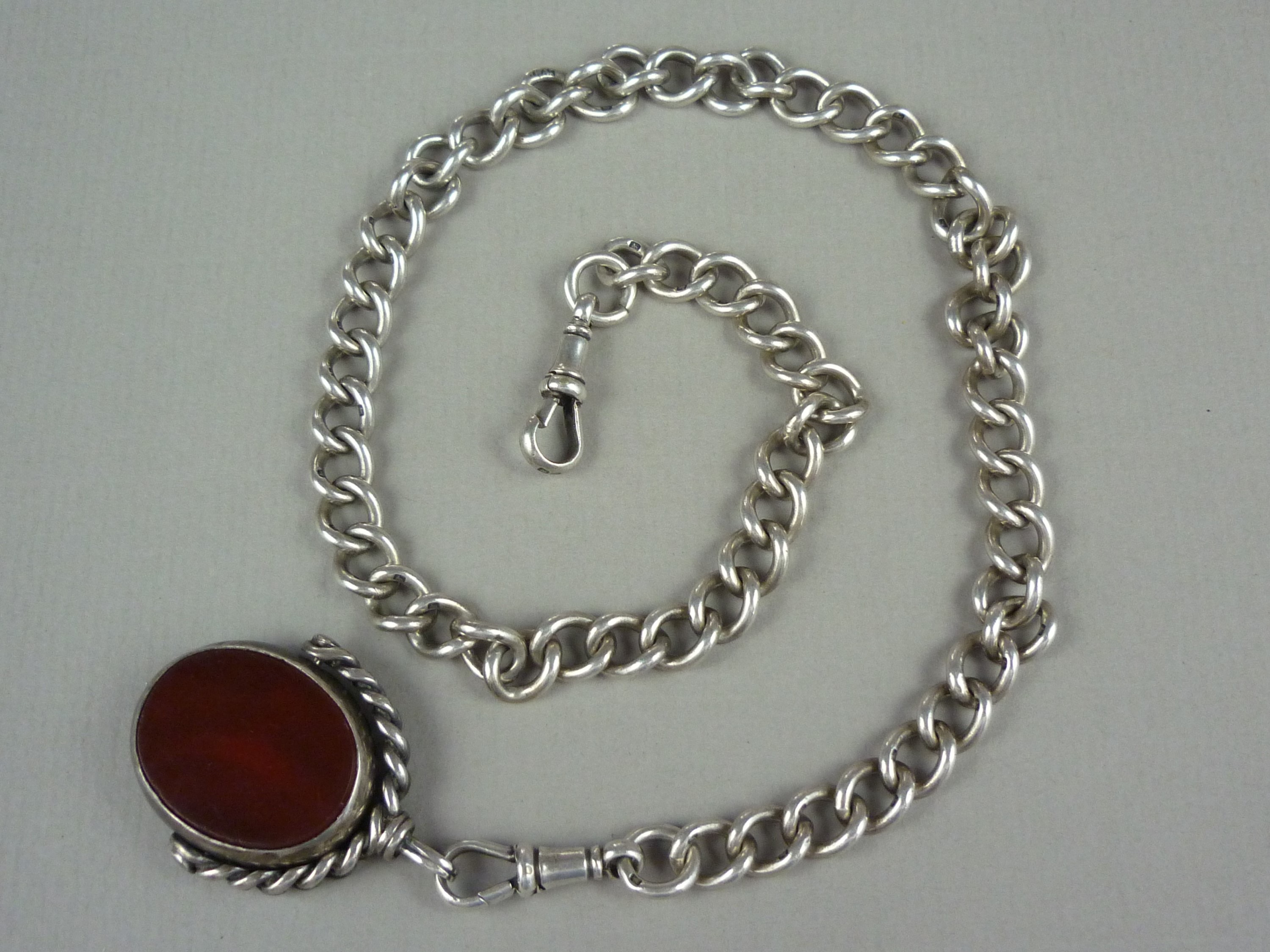 A Victorian gentleman's silver Albert watch chain, with swivel and fob seal, the latter set with