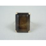 A vintage smoky quartz cocktail ring, the emerald cut stone of approximately 21 x 15 mm, claw set