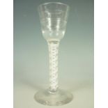 A mid 18th Century wine glass with Lynn rings to the conical-funnel bowl, on multiple spiral