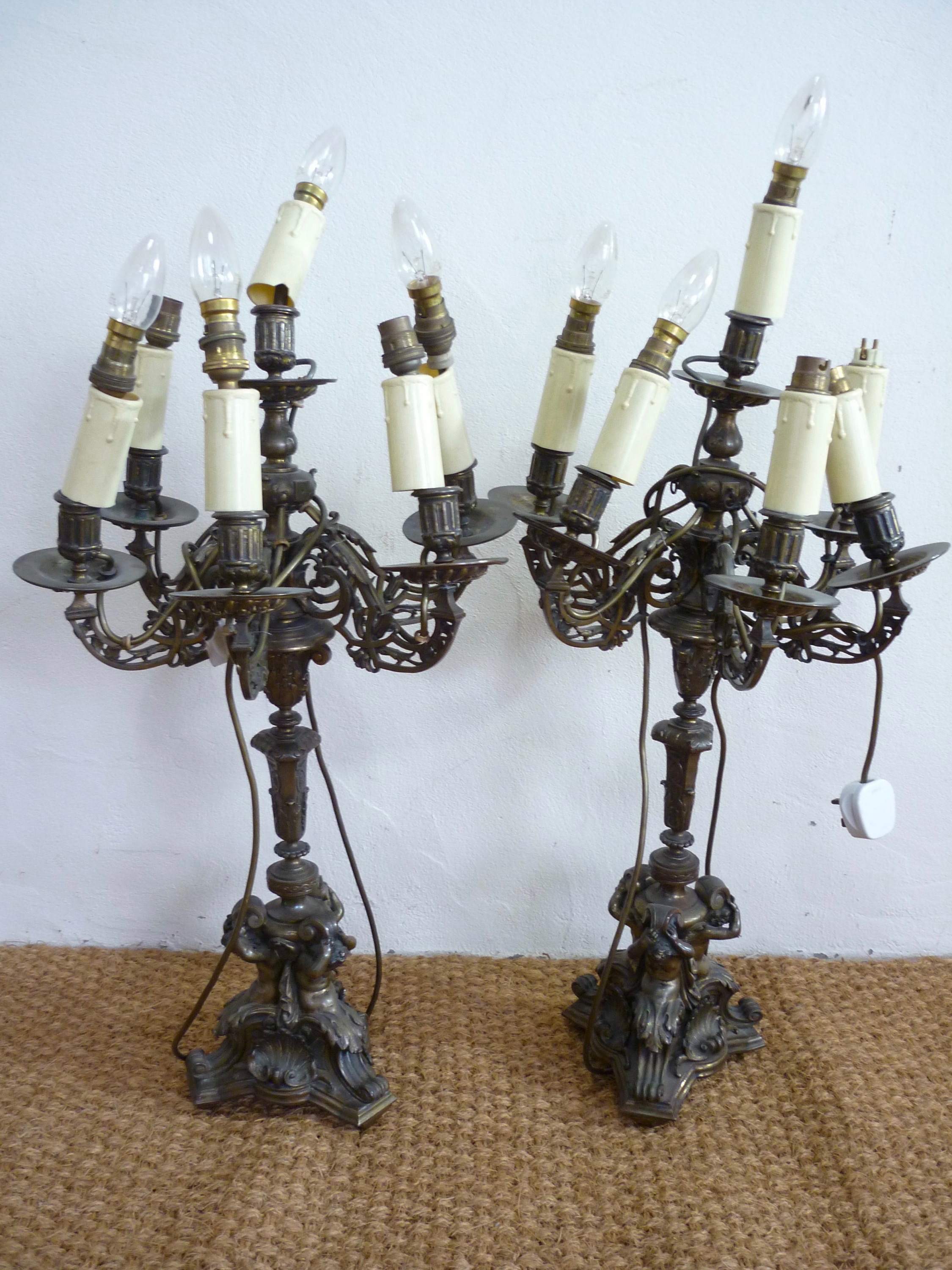 An impressive pair of late 19th Century cast brass five branch six light candelabra modelled after