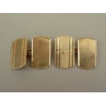 A gentleman's pair of 9ct gold cuff links, of rounded rectangular form with engine turned banded