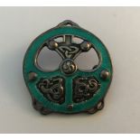 An enamelled white metal Celtic influenced brooch by Alexander Ritchie, stamped AR, IONA, 36 mm