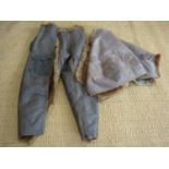 A pair of Second World War RAF Irvin sheepskin flying trousers, (one zip a/f), together with another