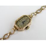 A 1930s lady's 9ct gold cased wrist watch, having Swiss made 15 jewel movement, oblong silvered face