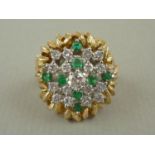 An impressive diamond and emerald cocktail ring, in an open tiered geometric arrangement with