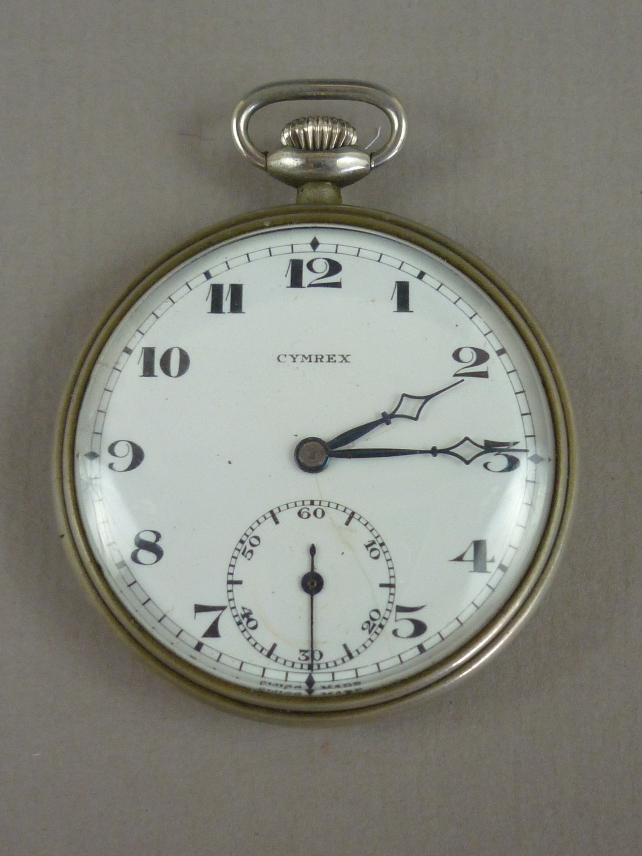 An early 20th Century nickel cased Cymrex pocket watch, with crown wound movement, white enamelled