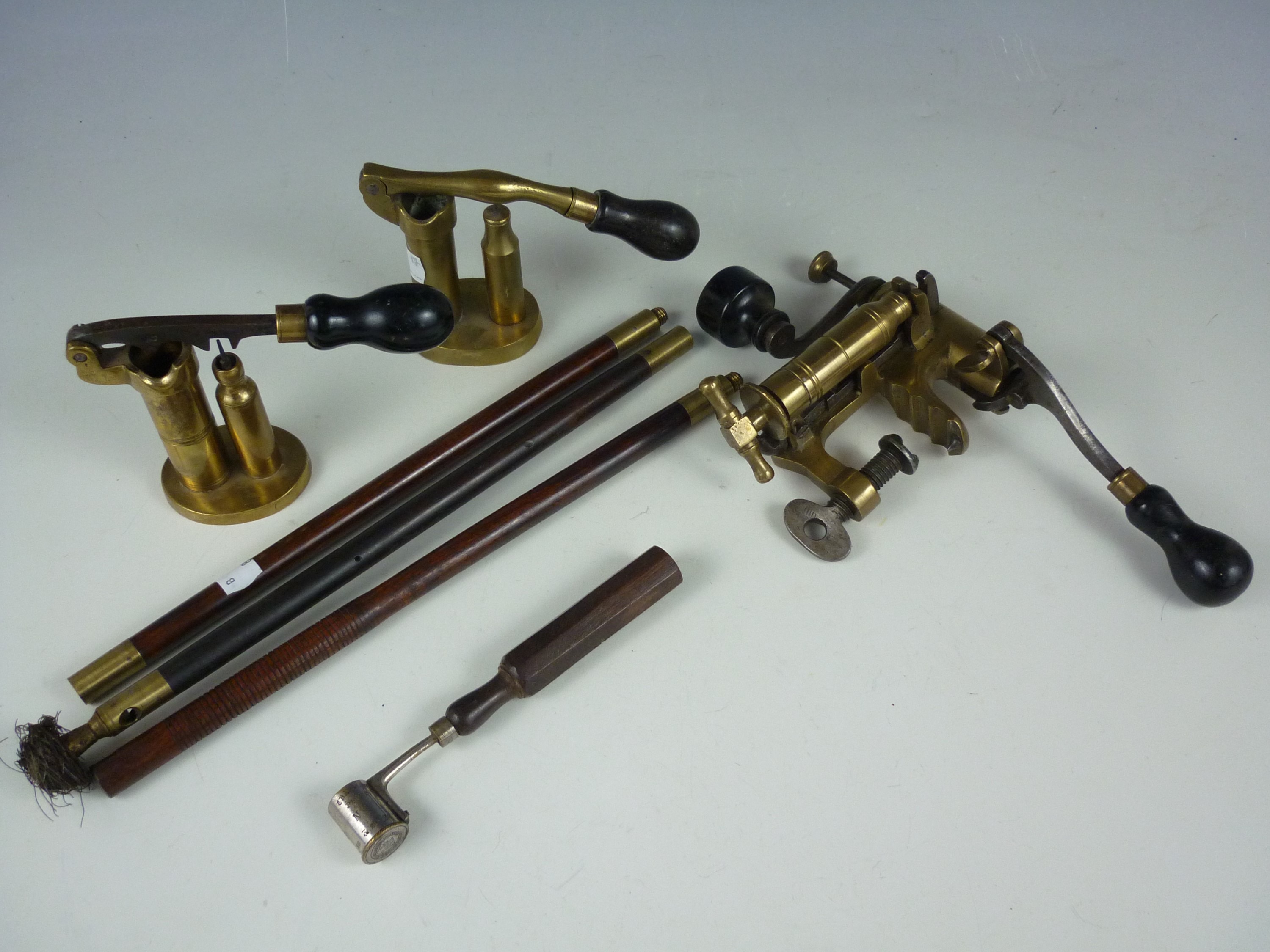 A group of late 19th Century gun tools including cartridge makers, a powder measure and barrel