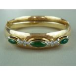 A high carat yellow metal, diamond and jade hinged bangle, the face rub set with three lenticular