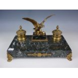 A 19th Century lacquered brass and variegated green marble ink standish, with eagle surmount flanked