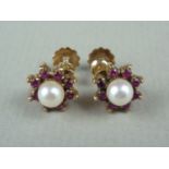 A pair of vintage ruby, pearl and yellow metal earrings, in a flower head cluster arrangement,