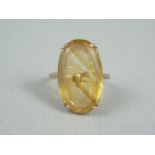 A vintage citrine cocktail ring, the oval cut stone of approximately 21 x 13 mm, claw set above a