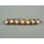 A ruby, pearl and high carat yellow metal bar brooch, in an alternating arrangement of single pearls