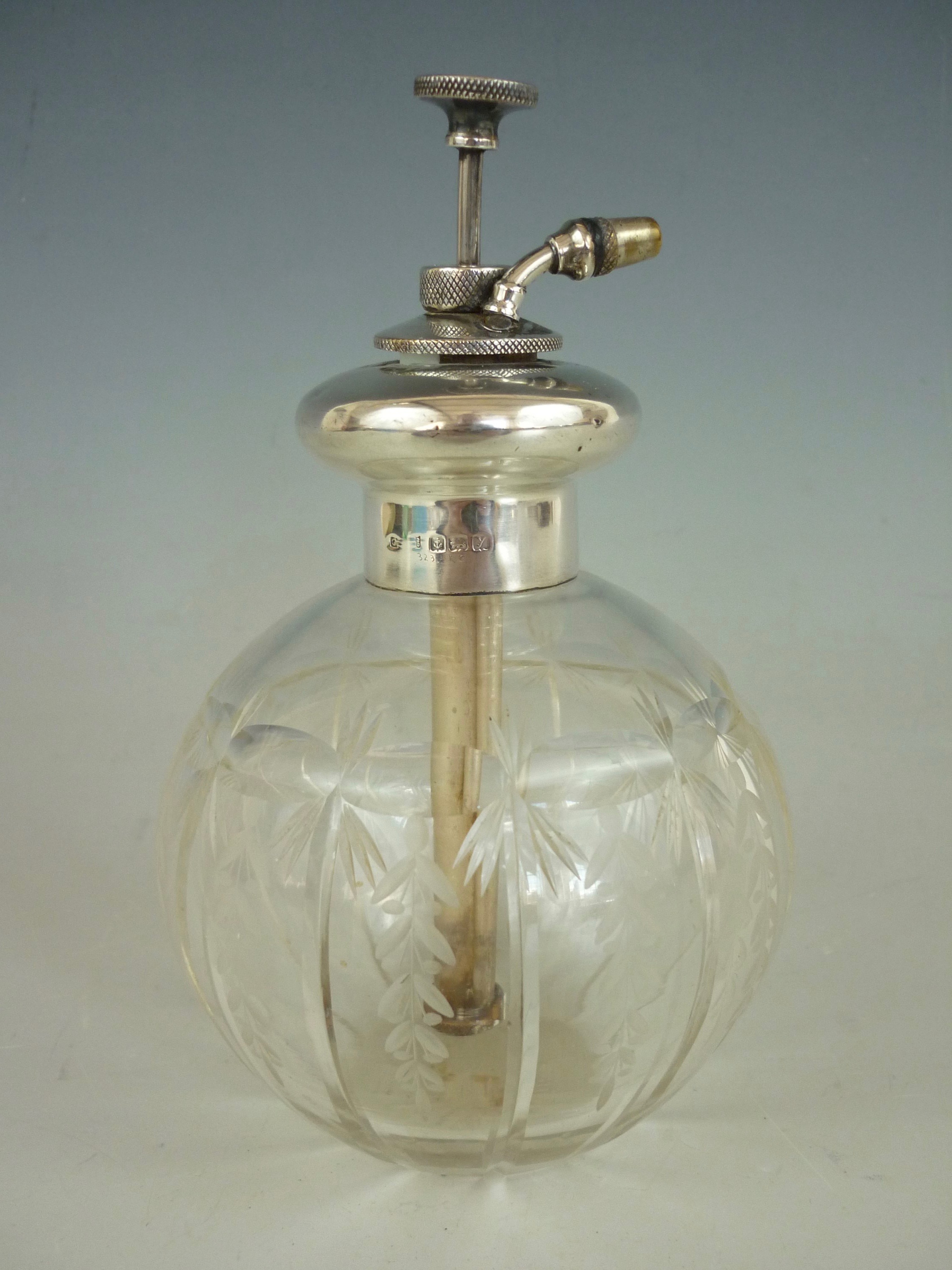 A George V silver and cut glass perfume atomiser, of grenade form, having wheel cut printies and