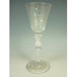 A mid 18th Century baluster wine glass of Newcastle type, having a conical funnel bowl wheel-cut