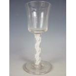 A Mid-18th Century wine glass, having a bucket-form bowl and multiple spiral opaque twist stem on