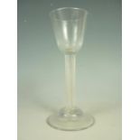 A George III wine glass, having round funnel bowl and finely-incised spirally-reeded stem on domed
