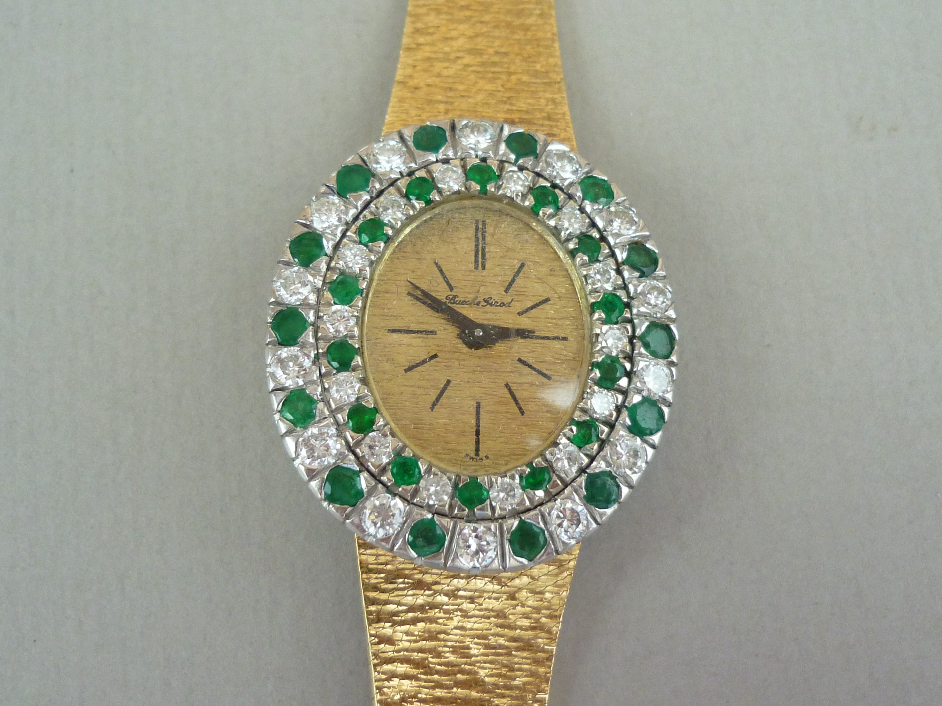 A vintage Bueche Ginod 18ct gold, diamond and emerald cocktail watch, having a mechanical