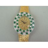 A vintage Bueche Ginod 18ct gold, diamond and emerald cocktail watch, having a mechanical