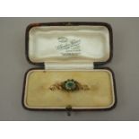 An early Victorian green stone and pearl bar brooch, with central flowerhead arrangement