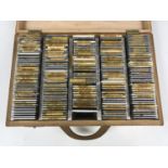 A cased collection of photographic positive slides of rock, pop, television and other celebrities