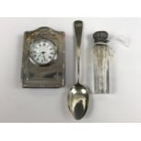 A miniature silver framed clock, a silver teaspoon and a Victorian silver-mounted cut glass smelling