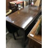 A mahogany drop leaf dining table