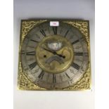 An 18th Century brass long case clock face with quartz movement, converting it for use as a wall