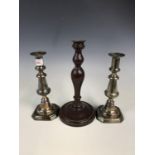 A pair of Victorian silver plated and brass candlesticks together with a turned mahogany