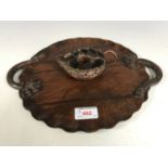 An oriental carved hardwood lily pad tray together with a copper chamberstick