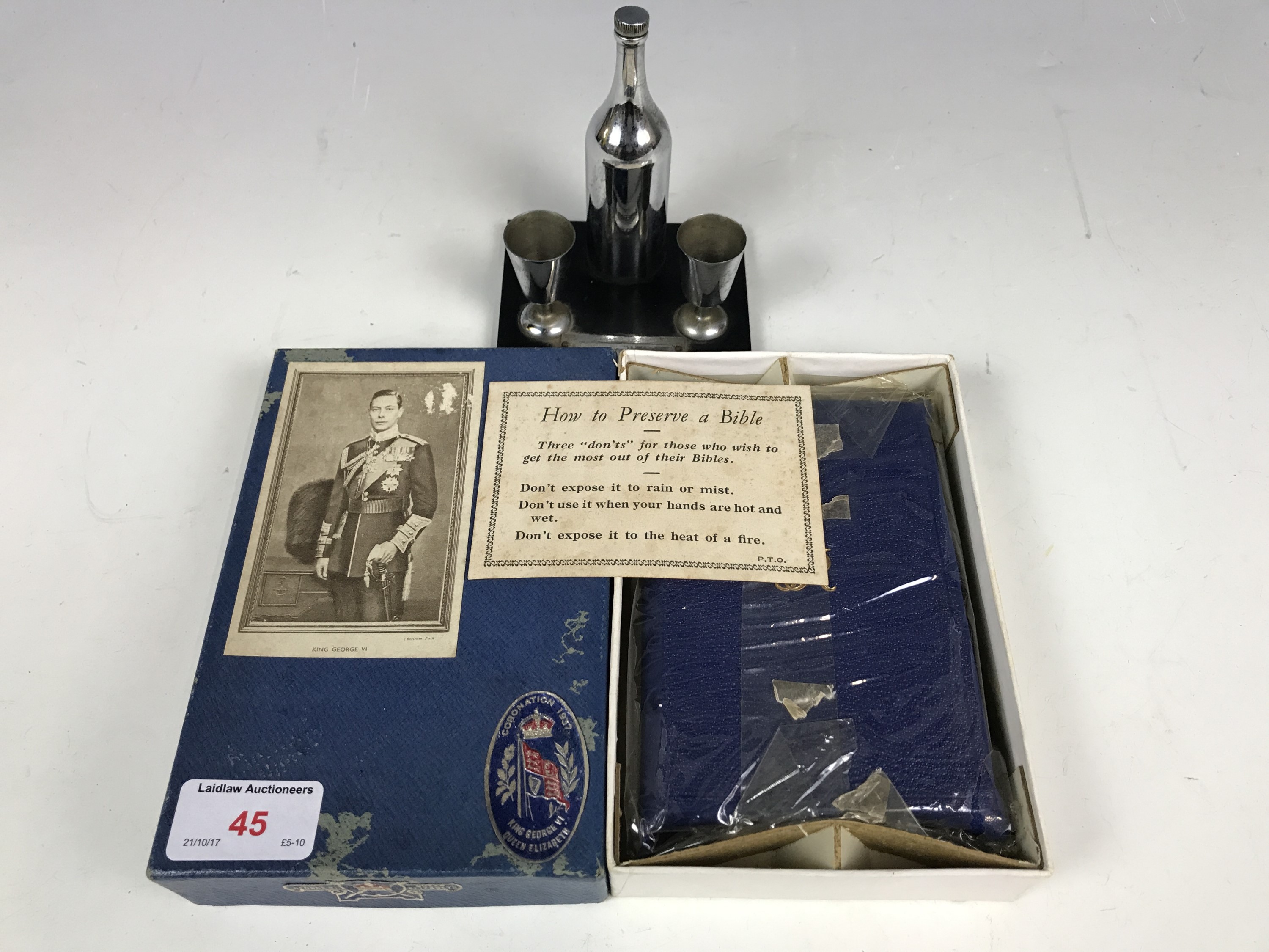 A novelty table cigarette lighter together with a cased George VI 1937 coronation bible