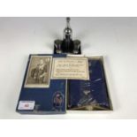 A novelty table cigarette lighter together with a cased George VI 1937 coronation bible