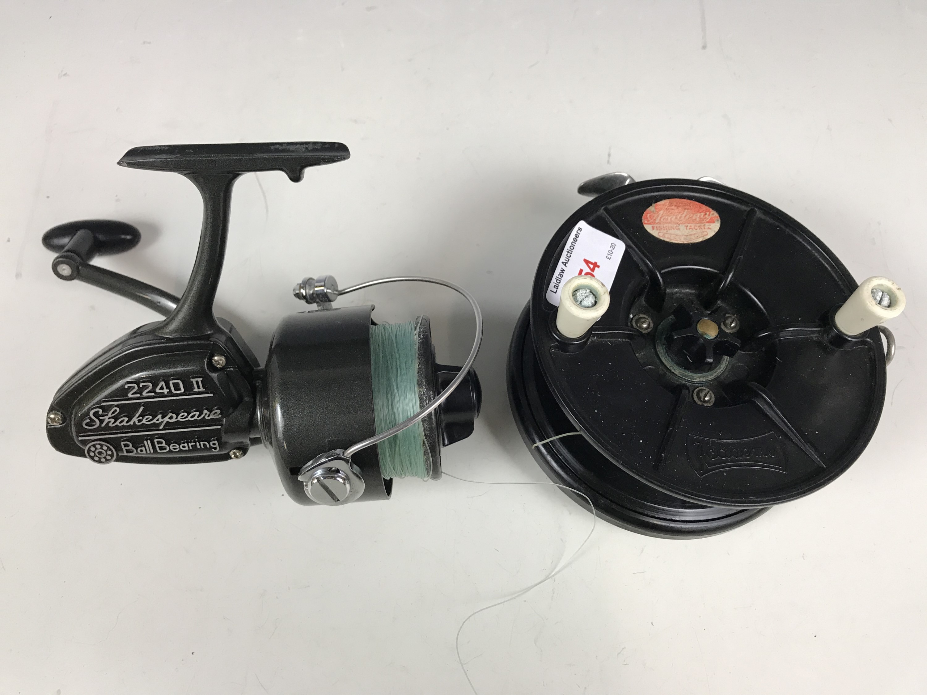 A vintage Academy centre pin fishing reel together with a Shakespeare 2240 II spinning reel