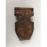 A late 19th Century Black Forest carved pocket watch case / night stand