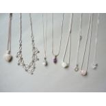 Eight contemporary white metal pendant necklaces, some set with paste stones, stamped 925, test as