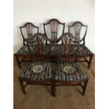 Five George III Hepplewhite style mahogany shield-back dining chairs, comprising one arm chair and