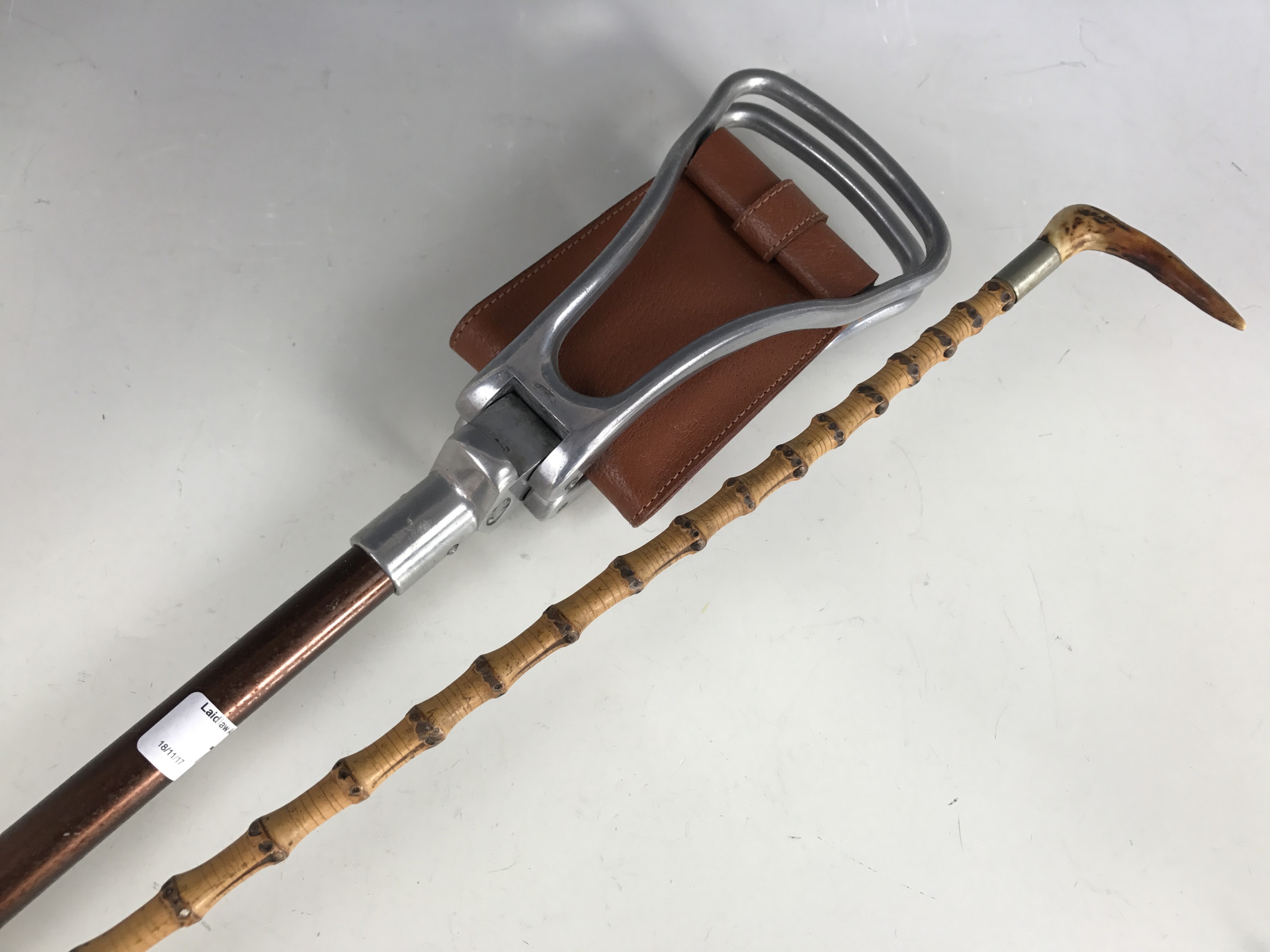 A Game Bird brand shooting stick together with an antique antler-handled bamboo walking cane