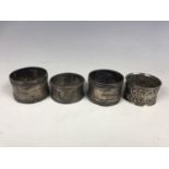 Four various silver napkin rings