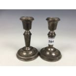 A pair of diminutive Elizabeth II silver candlesticks