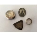 An Elizabeth II silver pill box, together with a school badge a church token and a white metal ring