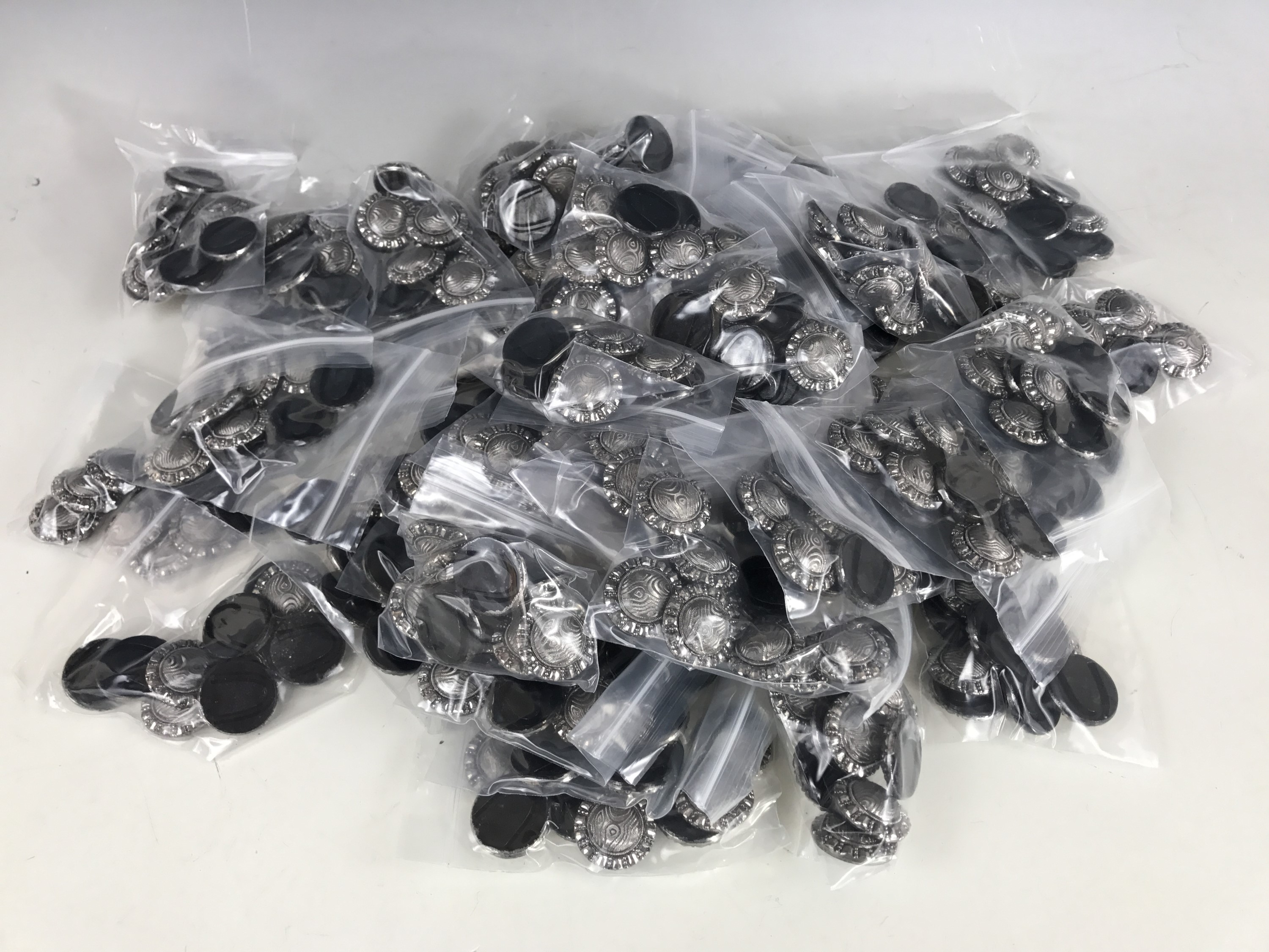 A large quantity of Victorian cut steel style modern 'buttons' for crafting, together with a plastic