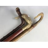 Two horn handled walking sticks together with two others