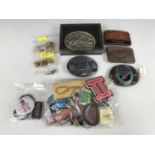 Four Canadian belt buckles together with a quantity of key rings and lapel badges etc