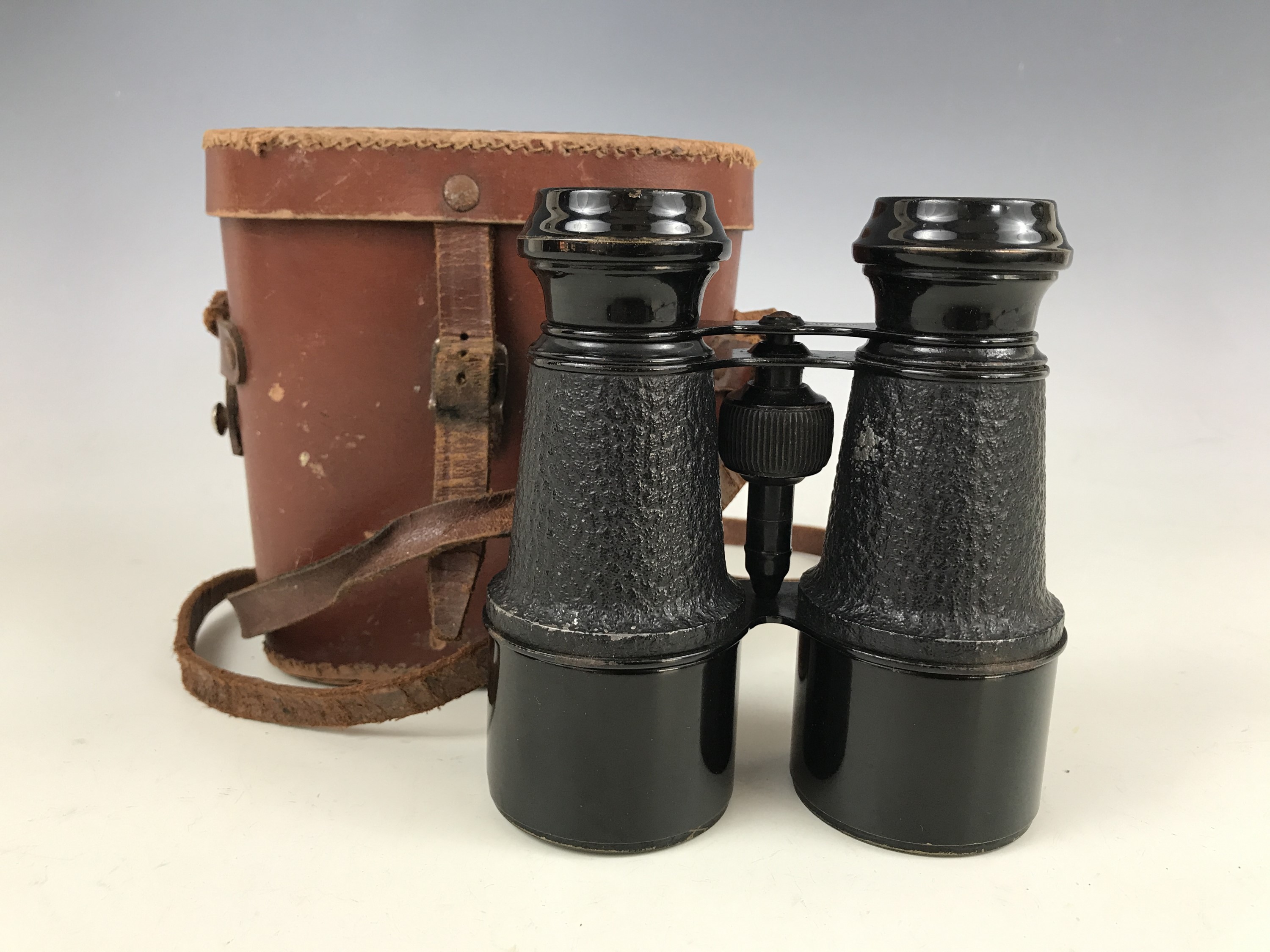 A cased pair of French field glasses