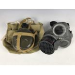 A Second World War civilian duty gas mask and haversack together with a water bottle