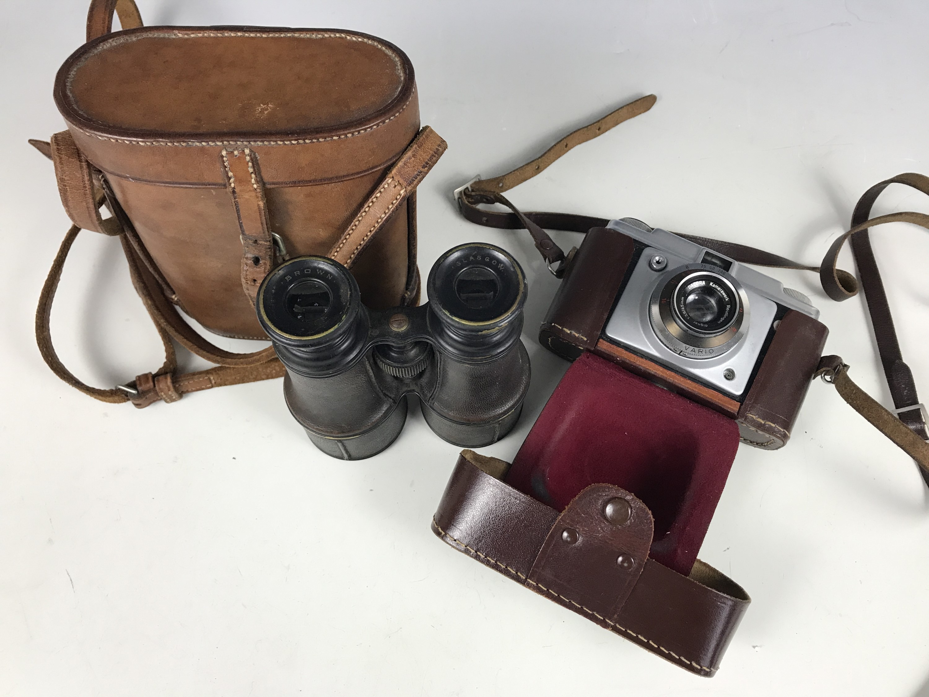 An early 20th century set of binoculars and an Ilford camera