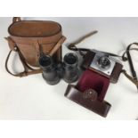 An early 20th century set of binoculars and an Ilford camera